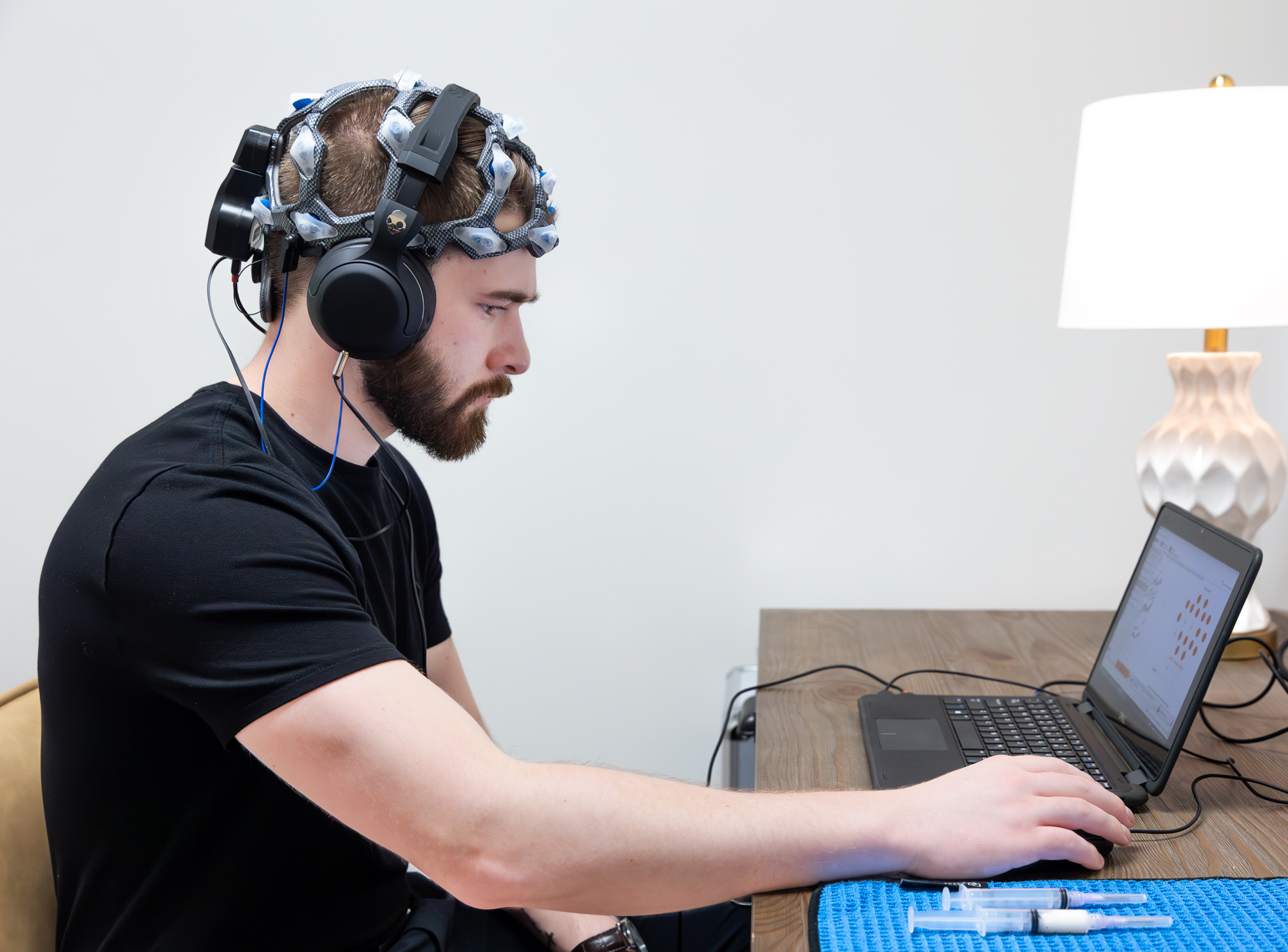 A patient wearing the WAVi EEG cap during a brain assessment at E. Michael Health